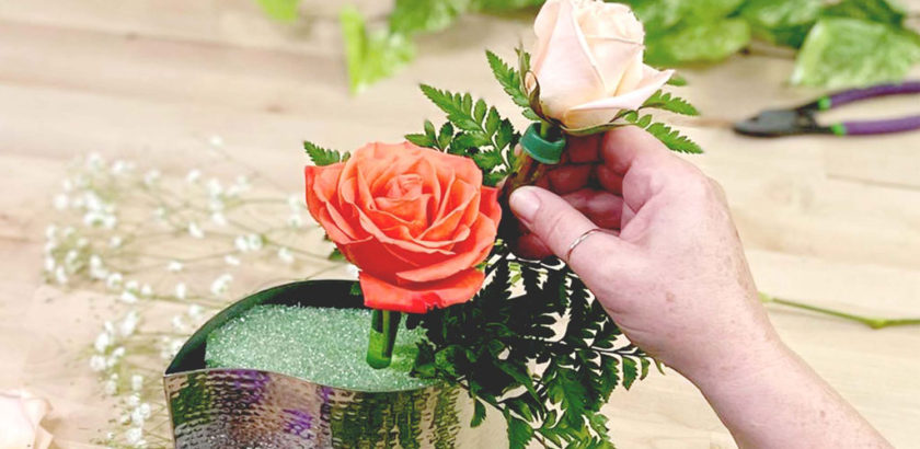 Two flowers placed in vase with foam