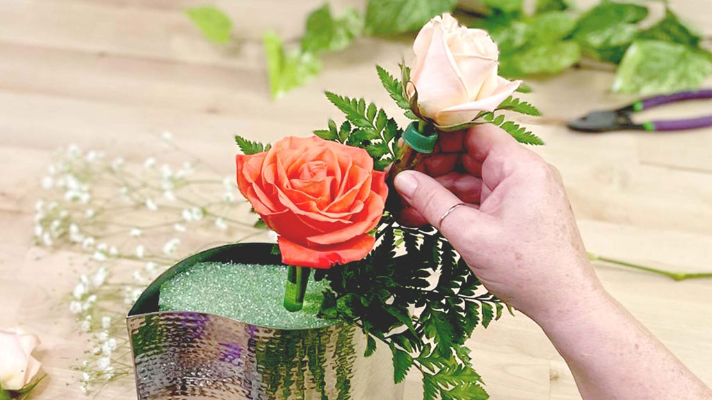 Two flowers placed in vase with foam