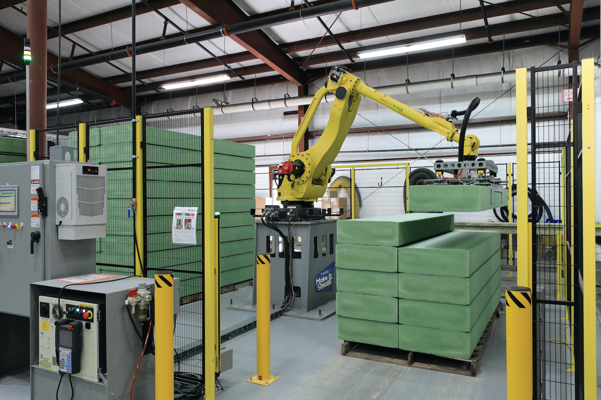 FloraCraft's robotic billet stacker, a machine that stacks billets automatically onto pallets, eliminating the need for team members to perform repetitive lifting from awkward positions.