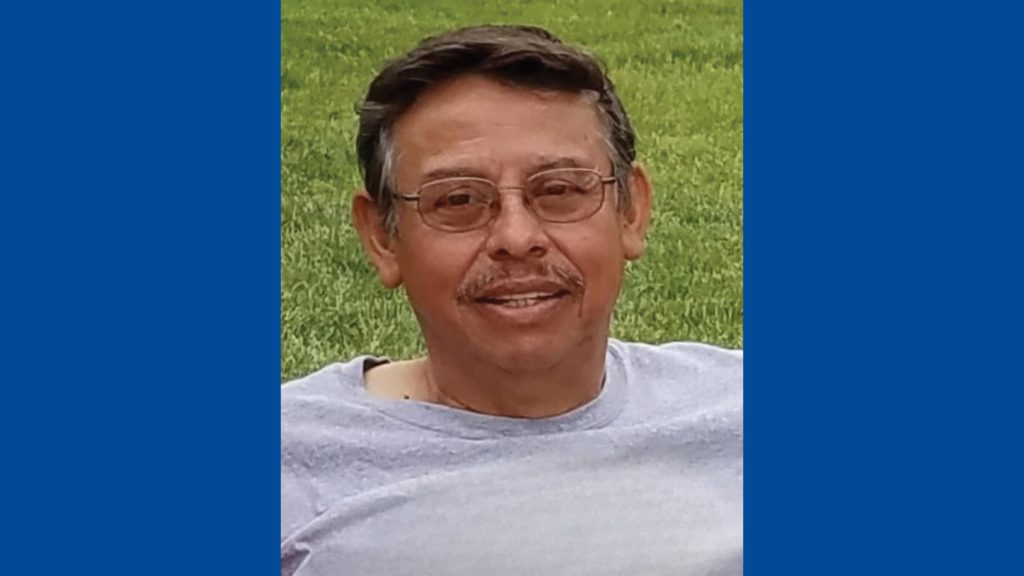 FloraCraft Wall of Fame Honoree Manuel Pardon in a gray shirt against a bright green grassy background.